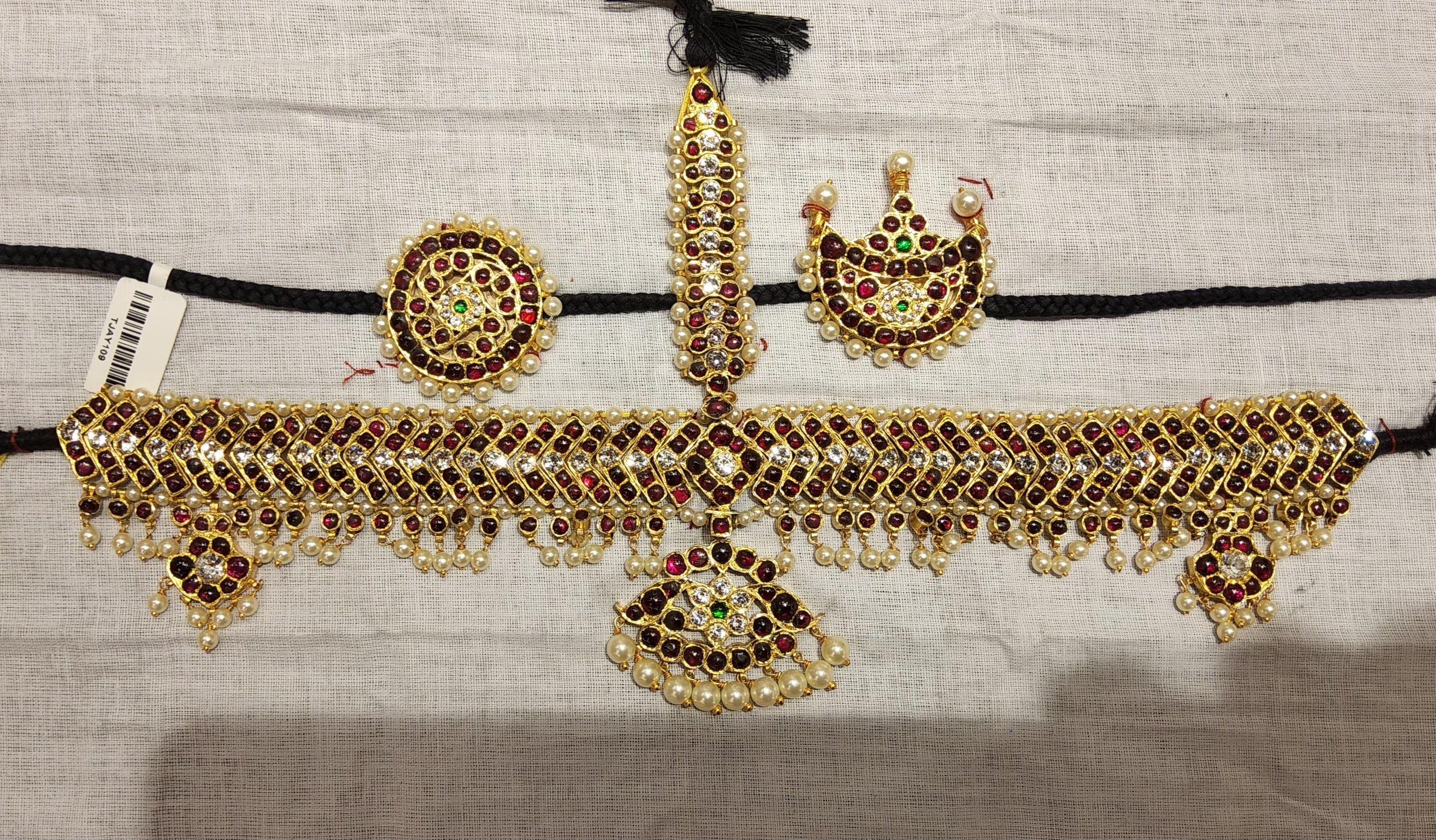 Close-up of 5 Stone V Headset, gold-leafed temple jewelry with clear stone accents, showcasing intricate craftsmanship.