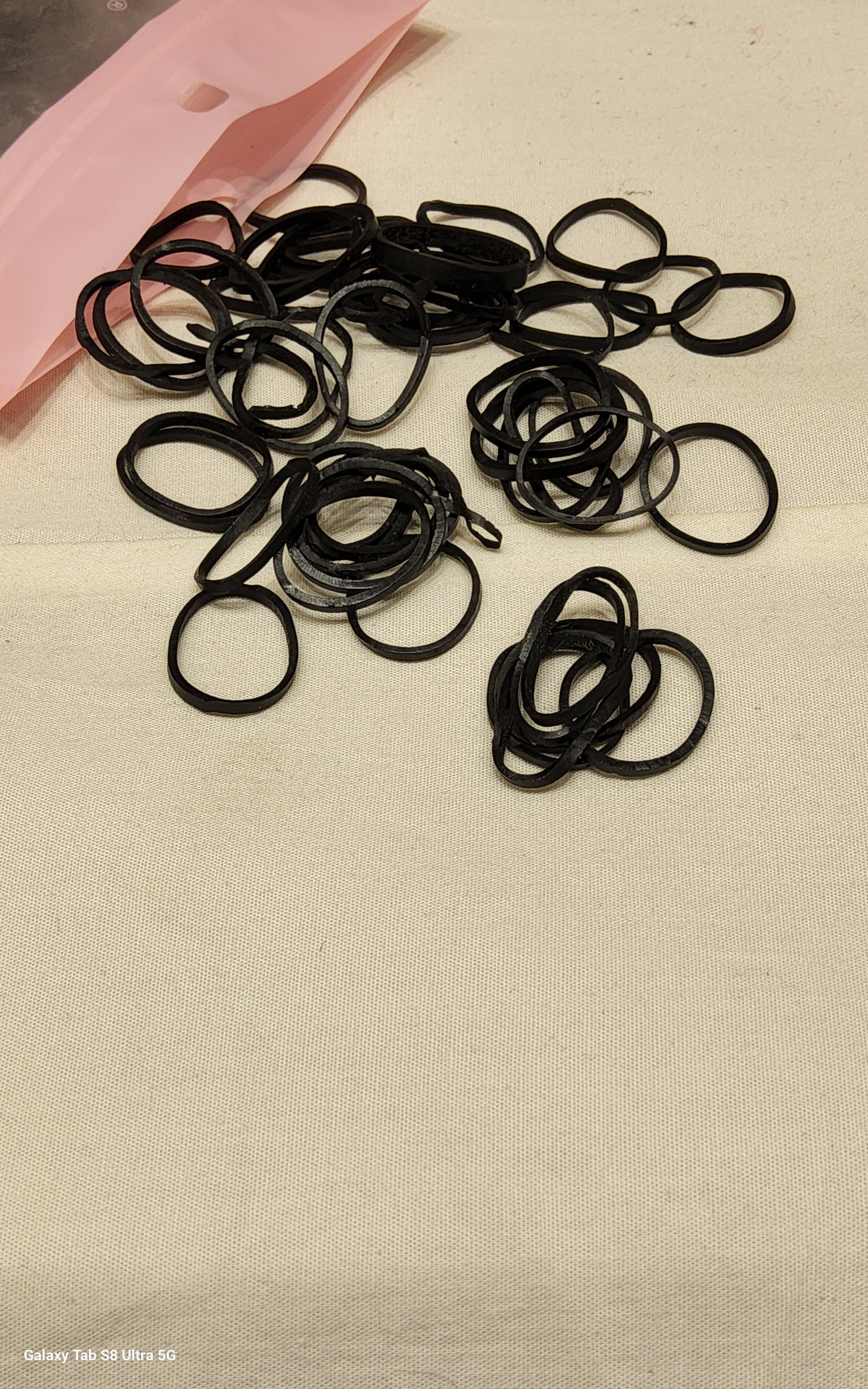 Single Black Strong Rubberband on white background for dancers, durable hair accessory for Bharatanatyam