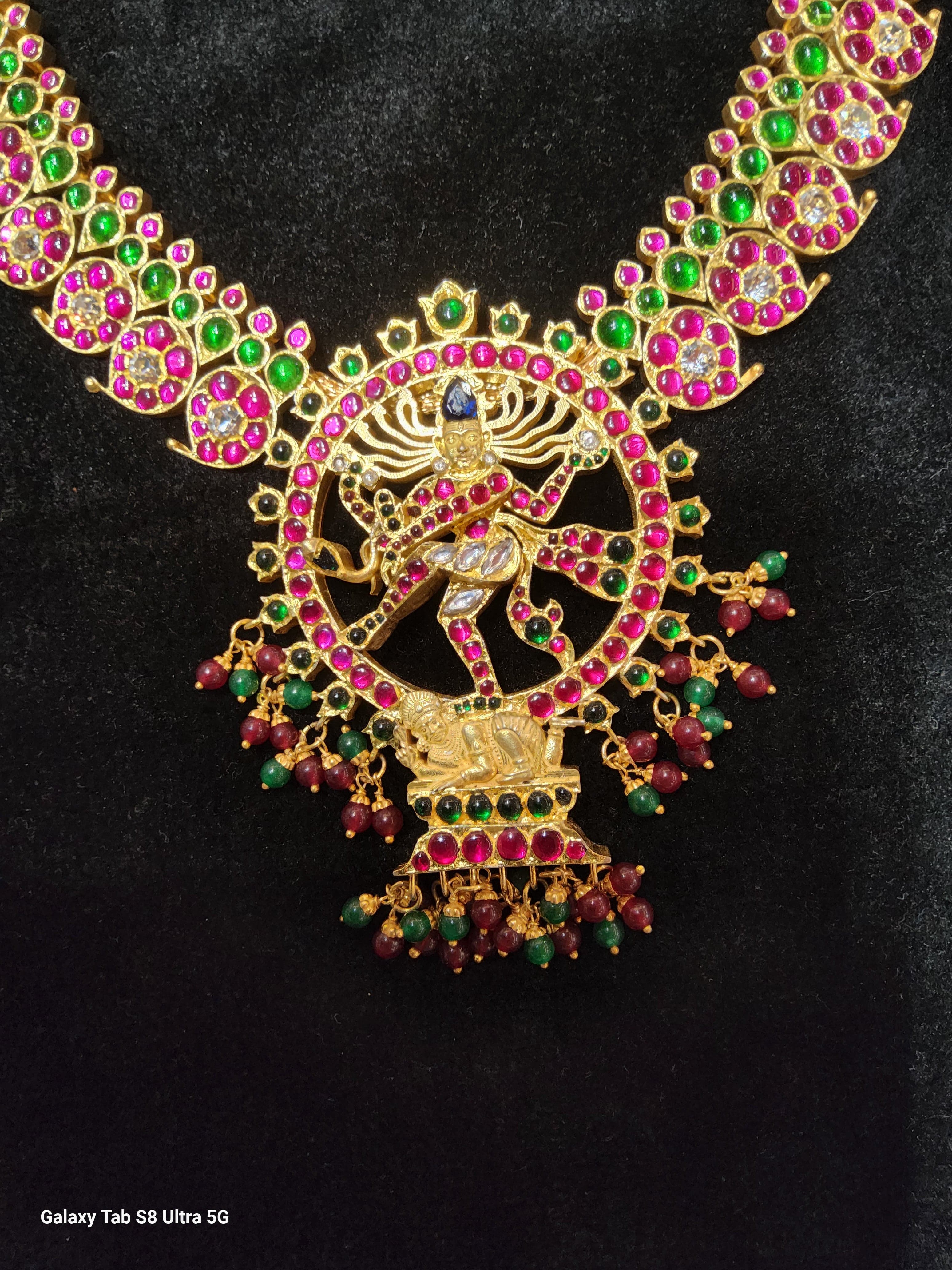 Natarajar pendant detail on Mango Haram. Ruby-colored temple jewellery for classical Indian dance performances.