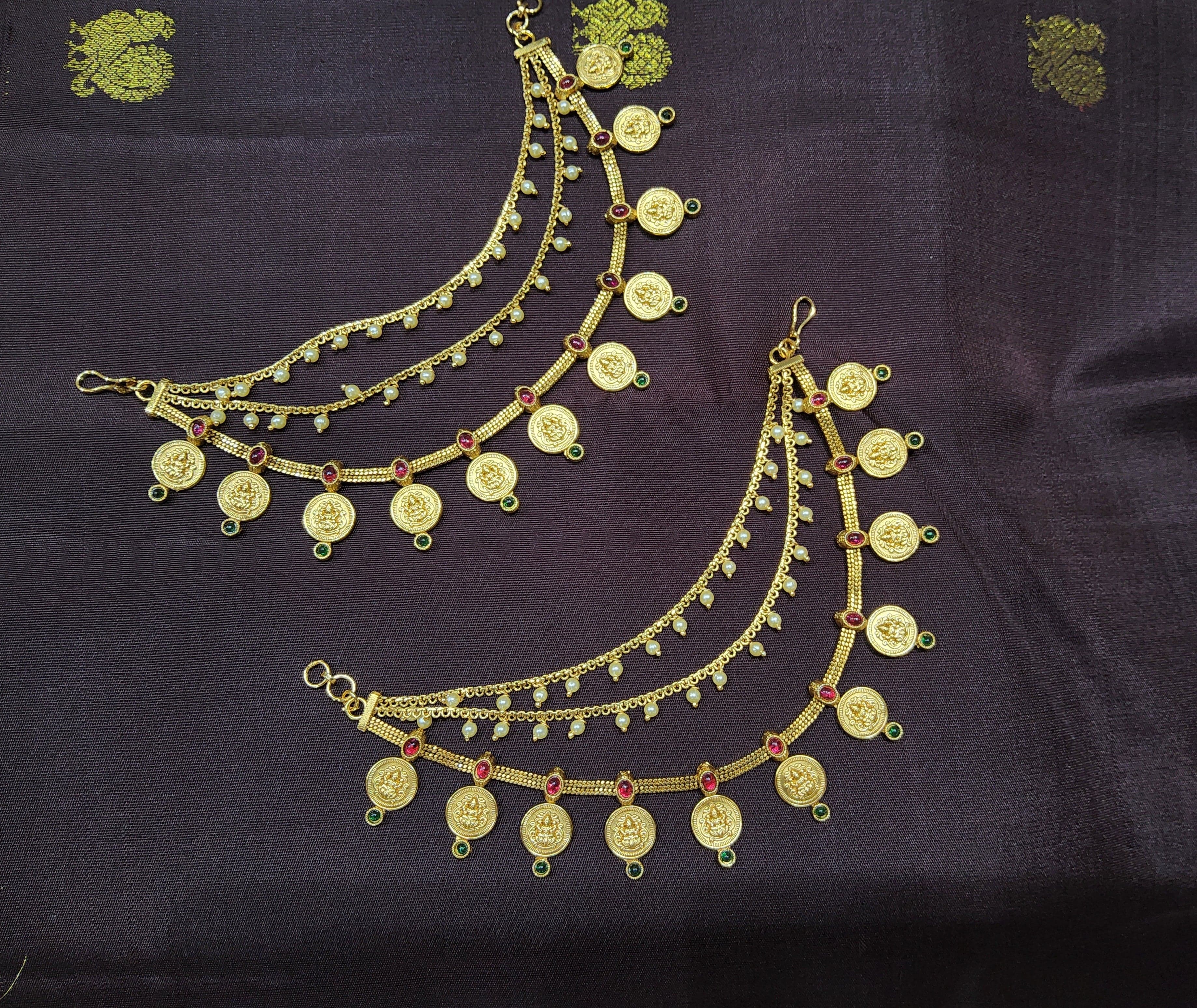 Close-up Antique Mattal, red green kemp stones, traditional Indian jewelry