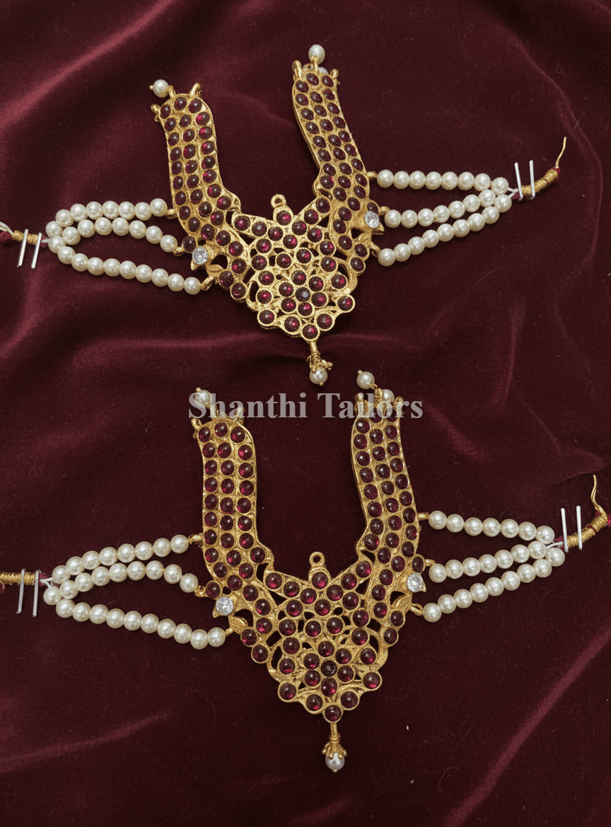 Vanki armlet close-up: gold foil temple jewellery detailing ruby and emerald kemp stones, bharatanatyam jewellery