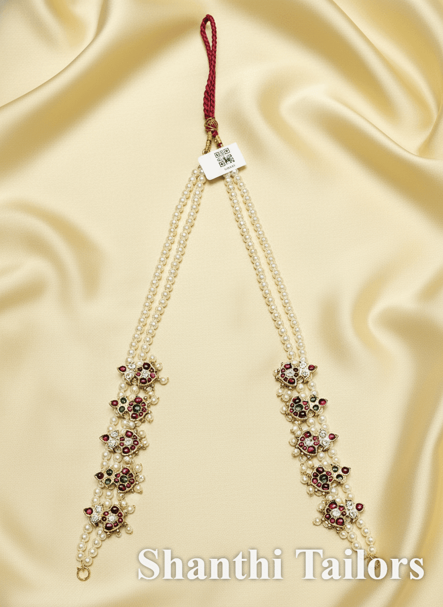 Close-up of Lakshmi pendant on temple jewellery haram. Silver base gold leaf. Bharatanatyam.