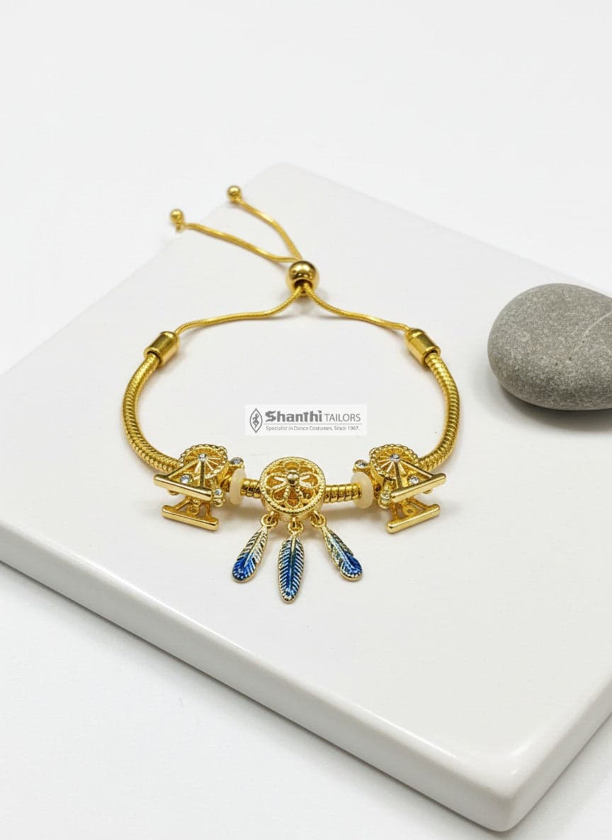 Golden Feather Drops Bracelet on wrist: Red feathers, adjustable slider. Stylish women's jewelry.
